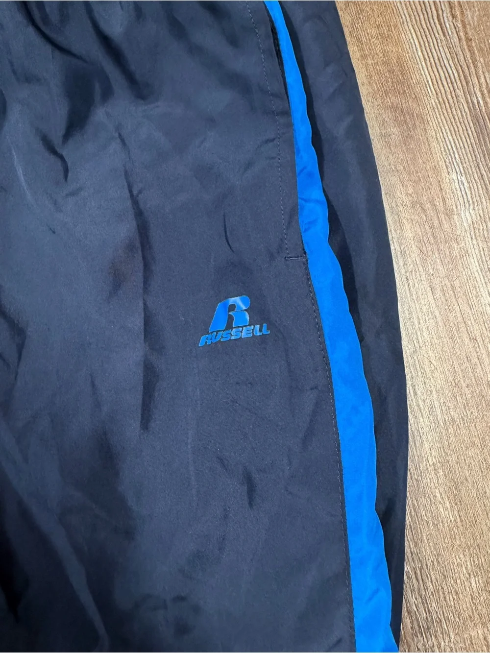 Vintage Russell Athletic navy blue track pants with blue side stripe, size M